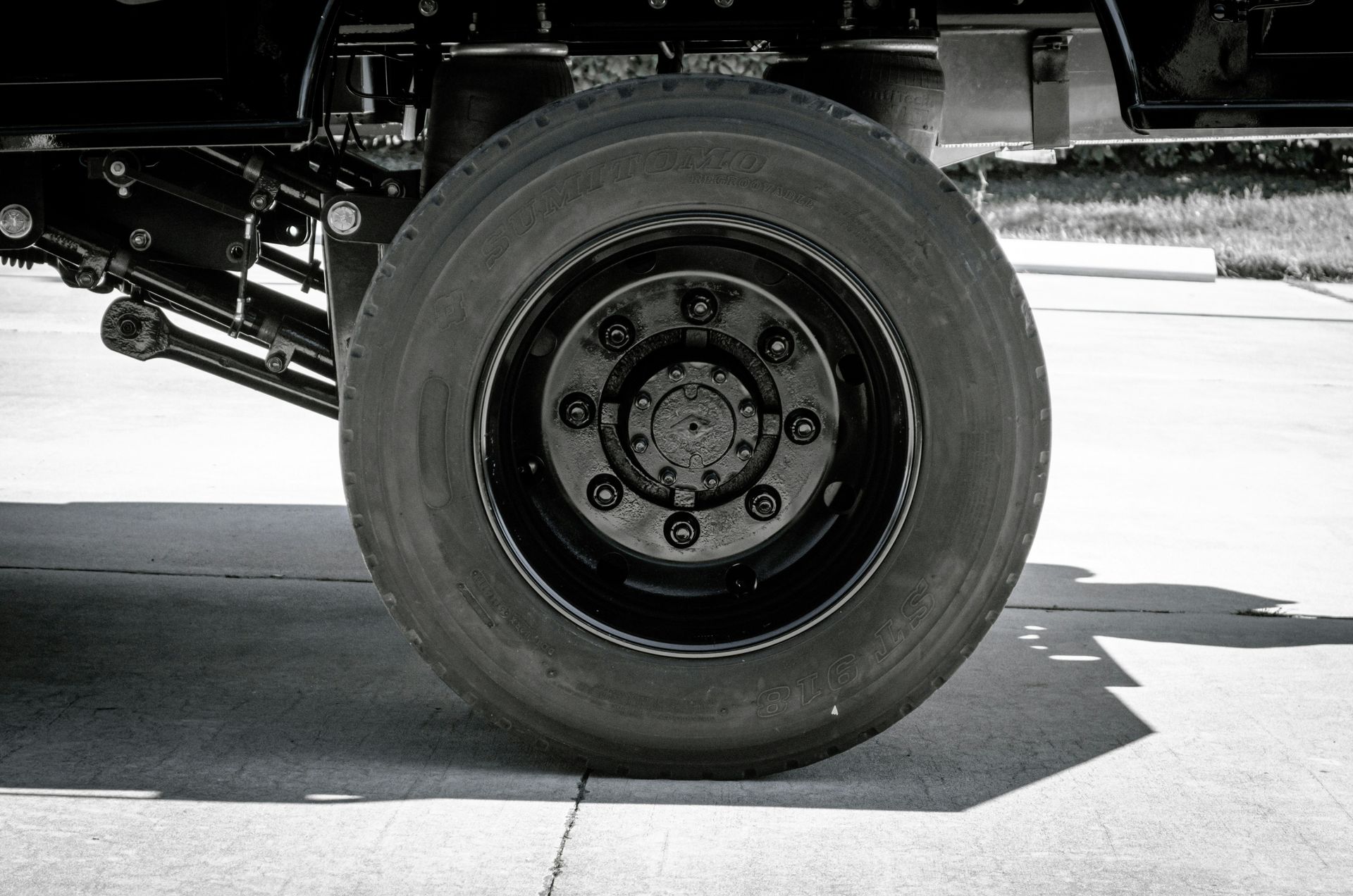 a black and white photo of a large truck tire